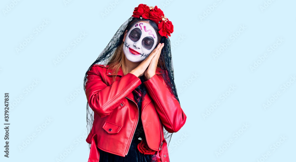 Woman wearing day of the dead costume over background sleeping tired dreaming and posing with hands together while smiling with closed eyes. Woman wearing day of the dead costume over background sleeping tired dreaming and posing with hands together while smiling with closed eyes.