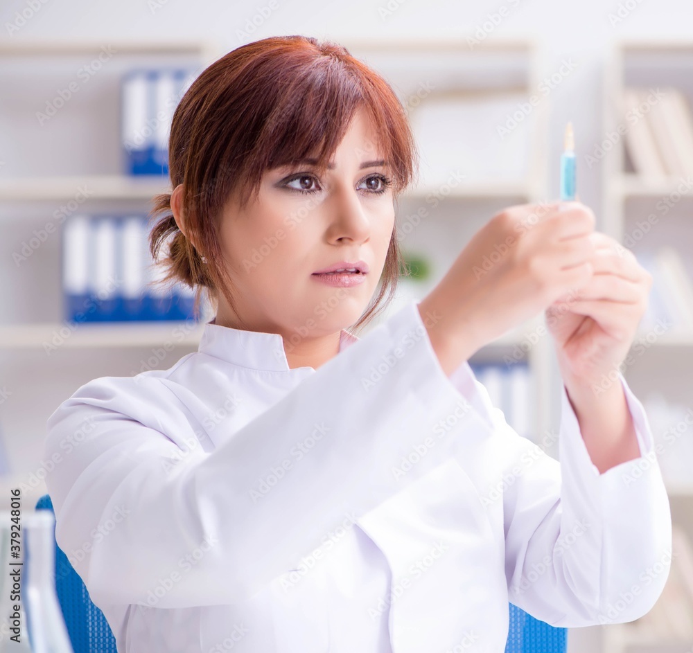 Female scientist researcher conducting an experiment in a labora Female scientist researcher conducting an experiment in a labora