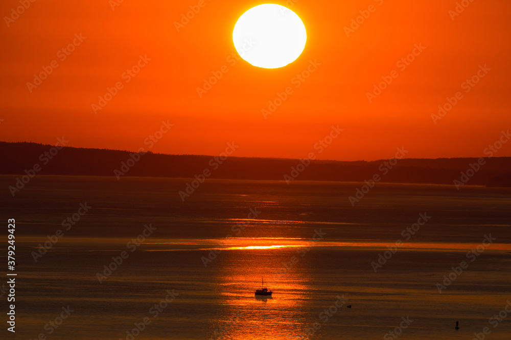 Smoky Sun Sets Over a Fishing Boat on Puget Sound 