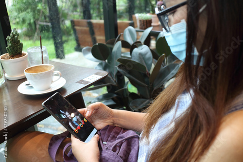 new normal lifestyle , woman using mobile phone for talking with her friend