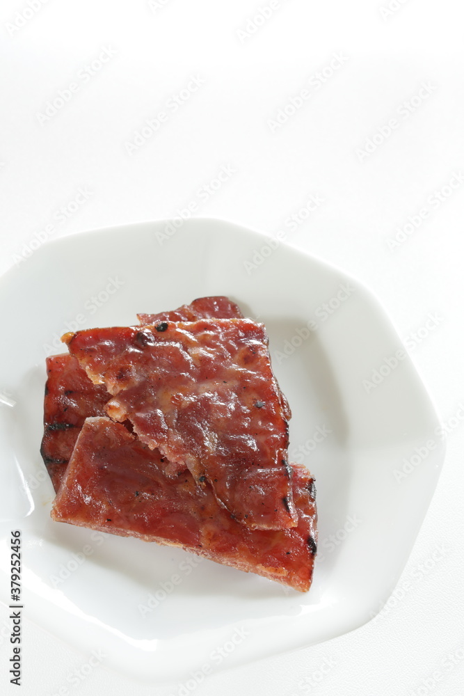 Taiwanese food, spicy beef jerky on dish with copy space Taiwanese food, spicy beef jerky on dish with copy space