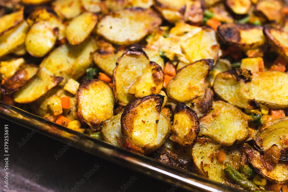 plant-based food, vegan potato bake with garden vegetables and nutritional yeast sauce