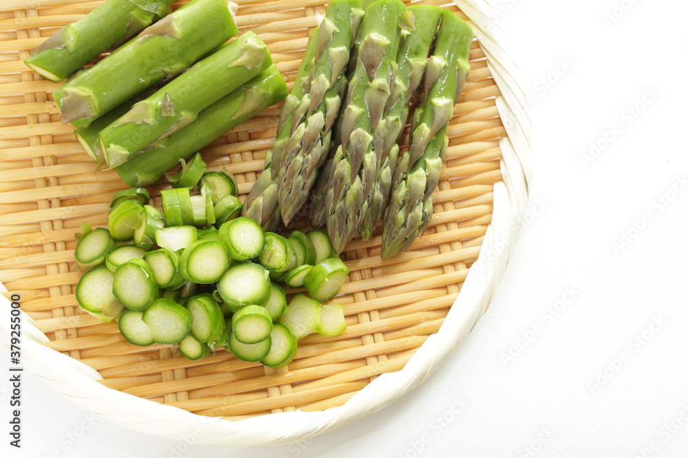 chopped green asparagus on bamboo basket