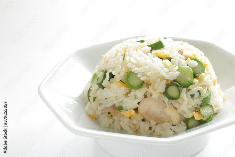 green asparagus and chicken fried rice on white dish green asparagus and chicken fried rice on white dish
