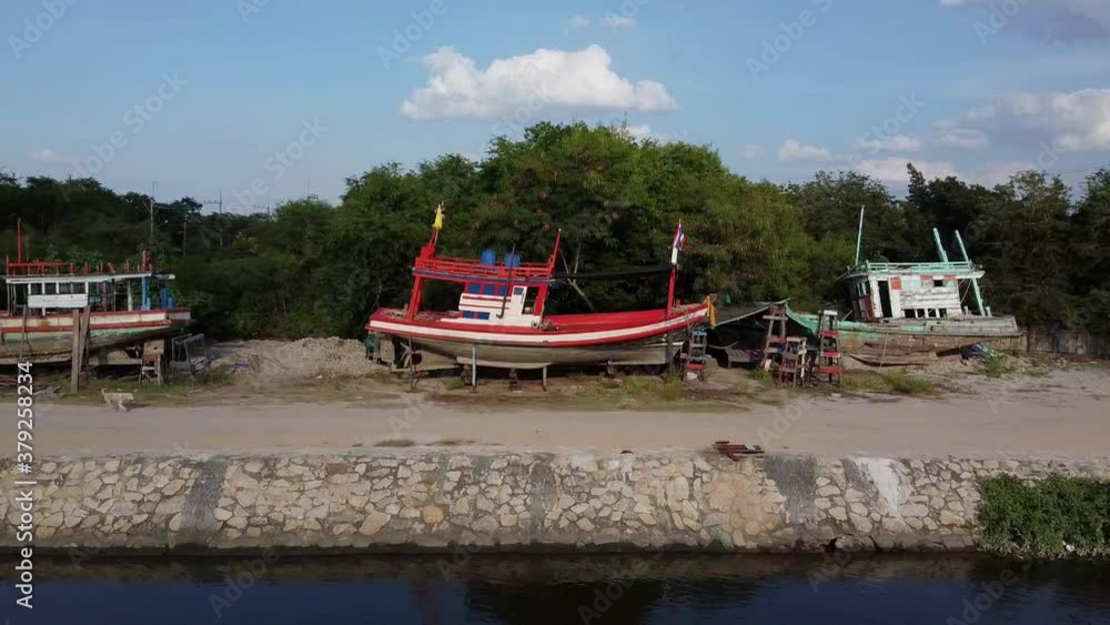 Sideways view of Thai fishing boats on dry land for repair Sideways view of Thai fishing boats on dry land for repair