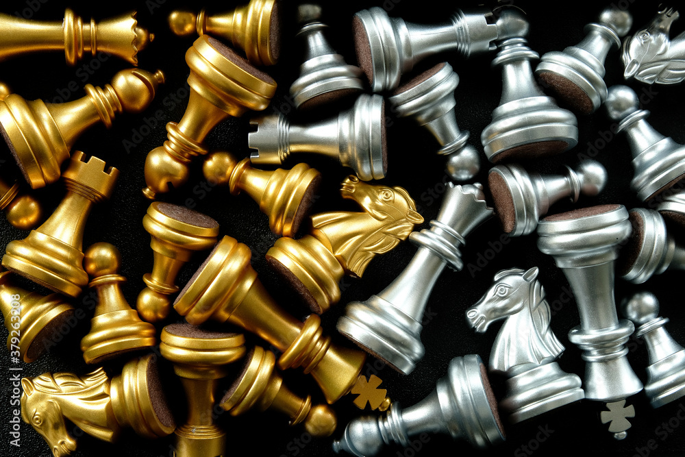 Chess set with golden and silver chess pieces arranged separately. Concept for intense clash or team rivalry, battle stalemate, showdown, no clear winner, evenly matched, or teams with equal strength. Chess set with golden and silver chess pieces arranged separately. Concept for intense clash or team rivalry, battle stalemate, showdown, no clear winner, evenly matched, or teams with equal strength.