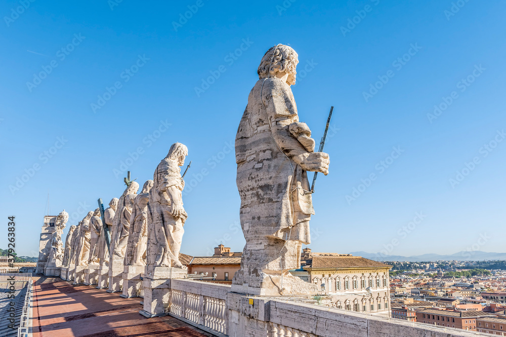 Near view of the ancient sculptures of the saint apostles on the roof of St. Peter's Basilica in Rome