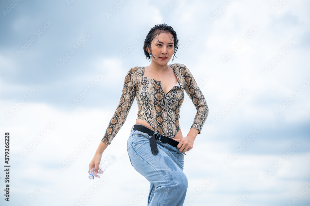 Young hip hop woman dancing on city background. Young hip hop woman dancing on city background.