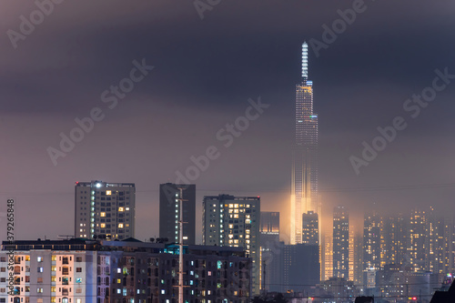 Spectacular view of a landmark 81 skyscraper sky in mist and clouds at Saigon at night in Ho chi minh city, Vietnam