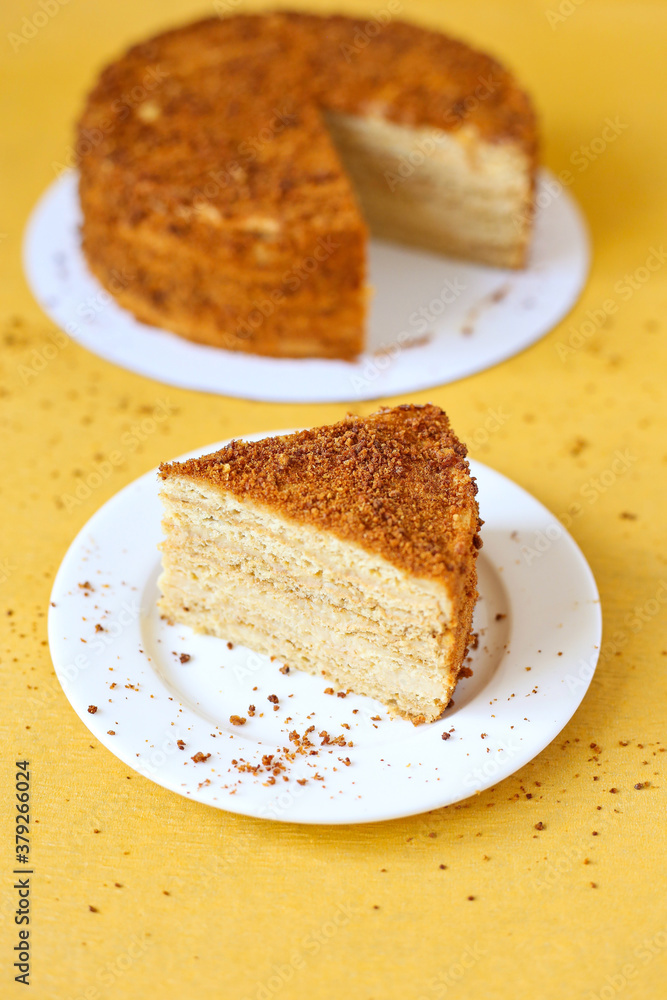 slice of honey cake on yellow background slice of honey cake on yellow background