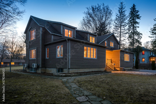 Real estate photography - exterior of single family house during twilight hours in Montreal s suburb