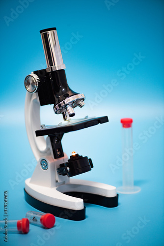 Laboratory lens of Microscope Isolated on bokeh/blur light blue scientific research background