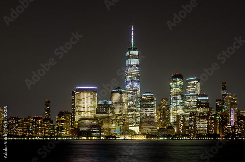 New York City Manhattan skyline panorama at night over Hudson river with reflections viewed from New Jersey