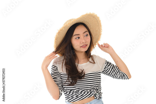 portrait of happy young asian female smiling wearing straw hat and summer dress isolated on white background. Leisure amd summer travel concept