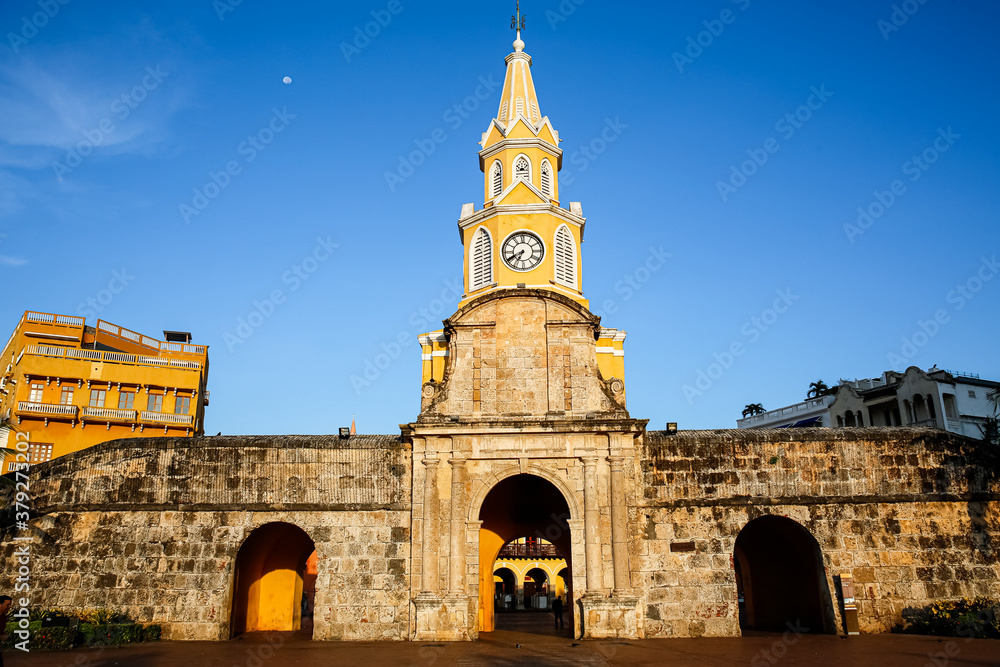View to Torre de Reloj (Clock Tower) with blue sky and warm light, Cartagena, Colombia, Unesco World Heritage
