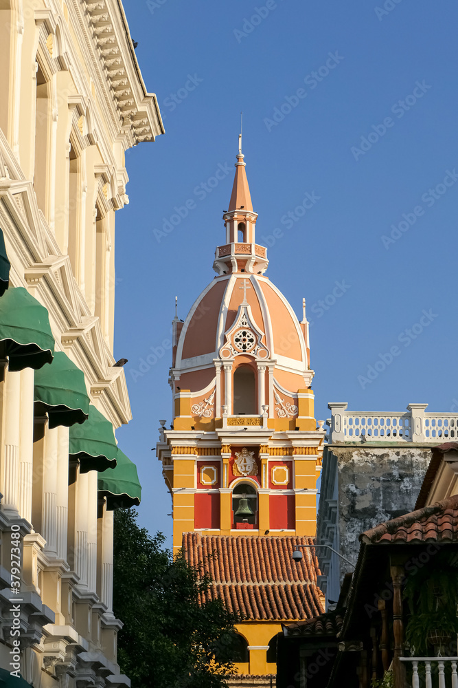 Obraz premium Close up view to the clock tower of the cathedral and white House facade with blue sky, Cartagena, Colombia, Unesco World Heritage