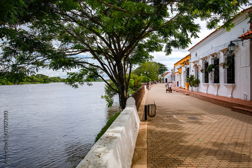 River promenade with typical historic houses, trees and river,  Santa Cruz de Mompox, Colombia, World Heritage
 photo