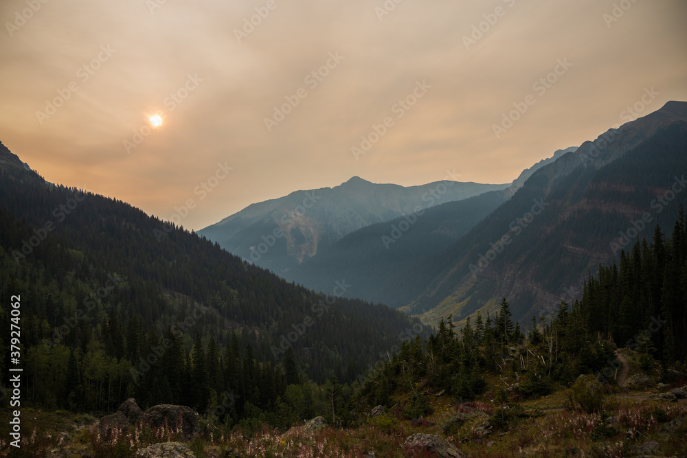 mountain sunrise through thin smoke