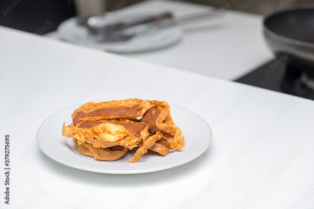Fried peking duck as served in white plate at restaurant. Chinese style Fried peking duck as served in white plate at restaurant. Chinese style
