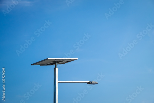 Solar power panels station on blue sky outdoor background. Environment electricity renewable sun energy. Photovoltaic eco-green technology research saving. Business battery cells array clean system.