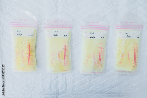 Above view of breast milk frozen in storage bags for newborn baby on white background. Breastfeeding or early childhood development concept. Top-down photo