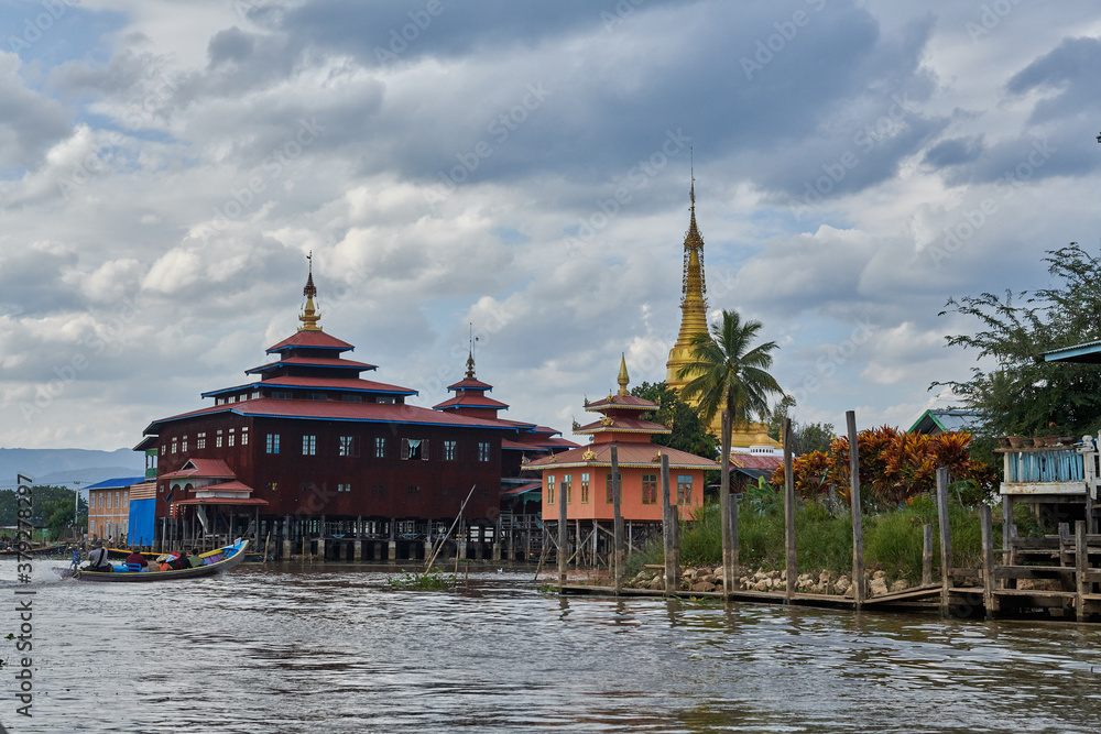 Inle Lake is in the Shan Hills of Myanmar. At its southwestern edge, Phaung Daw Oo Paya is a tiered pagoda with gilded Buddha statues. In the hills, near the market town of Indein, the stupas of Shwe Inle Lake is in the Shan Hills of Myanmar. At its southwestern edge, Phaung Daw Oo Paya is a tiered pagoda with gilded Buddha statues. In the hills, near the market town of Indein, the stupas of Shwe