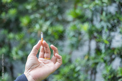 hand of man holding a cigarette