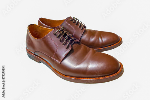 Man brown shoes isolated on white background. Leather footwear with cut out.