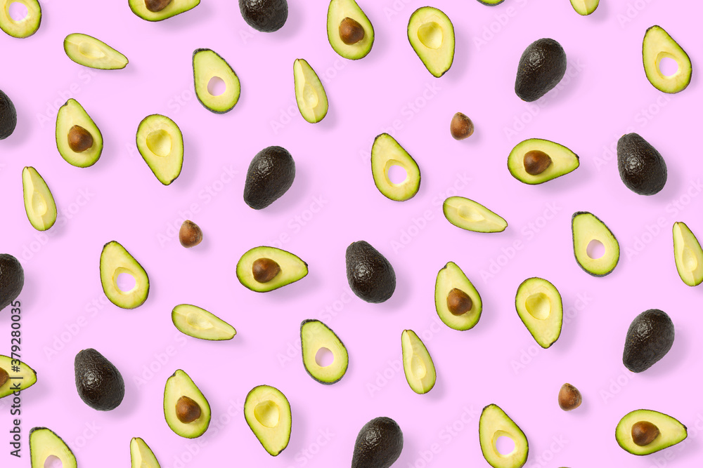 Avocado. Background made from isolated Avocado pieces on pink background. Flat lay of fresh ripe avocados and avacado pieces. Avocado. Background made from isolated Avocado pieces on pink background. Flat lay of fresh ripe avocados and avacado pieces.