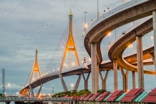 The beautiful view of Bhumibol Bridge during the night time in Bangkok at Thailand, known as the Industrial Ring Road Bridge over the Chao Phraya River. photo