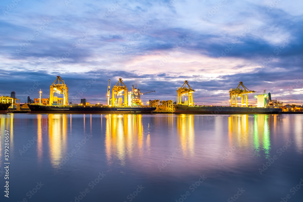 Harbor with anchored ship. Container cargo freight ship with working crane bridge at a shipyard in for logistic transportation import and export at Asia haven port background, Samutprakarn, Thailand.