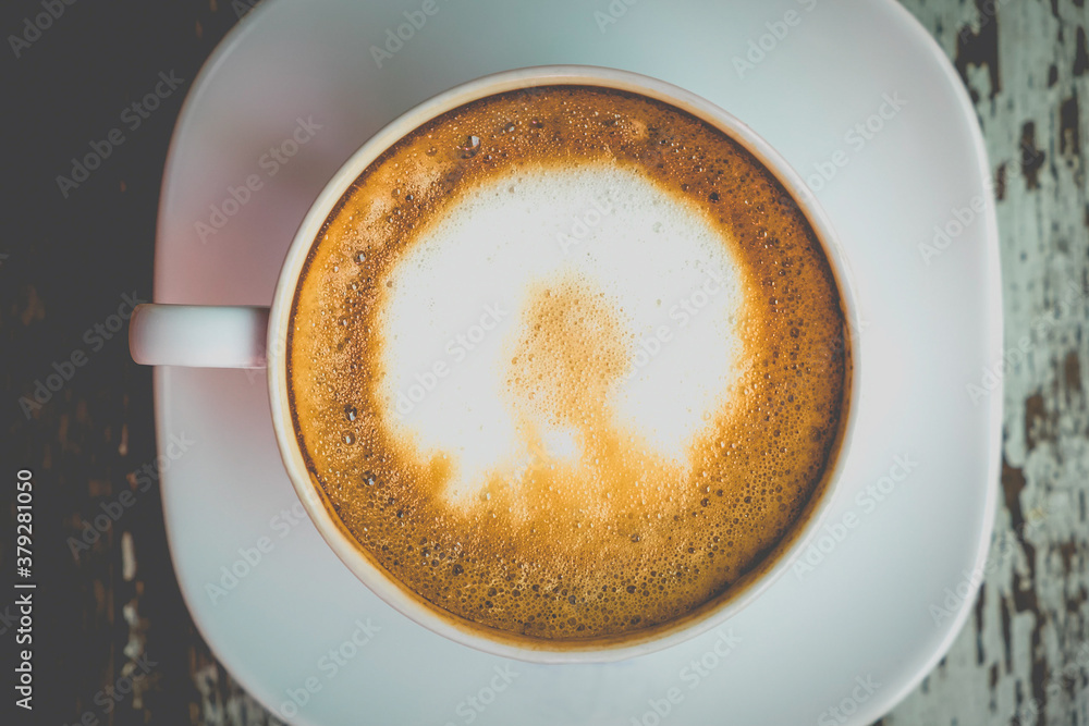 Hot latte art on wooden table at coffee shop. White cup of coffee the best start to any morning at cafe with copy space. Top view Hot latte art on wooden table at coffee shop. White cup of coffee the best start to any morning at cafe with copy space. Top view