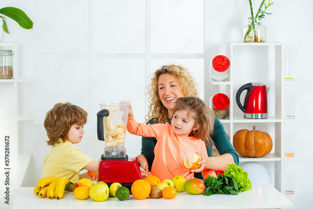 Mother and her two children blending cocktail with fruits and drinking smoothie, mothers day concept, Mother and her two children blending cocktail with fruits and drinking smoothie, mothers day concept,