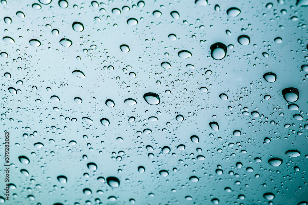 Colourful drops of rain on a window glass in the city. Image of raindrops texture background. Colourful drops of rain on a window glass in the city. Image of raindrops texture background.