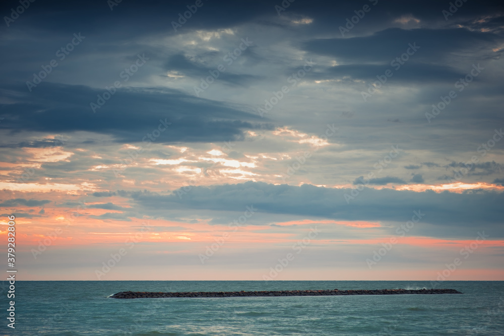Naklejka premium Beautiful golden sunset with blue sky over the horizon on the beach background, Thailand. Tropical twilight colorful sunrise from the landscape sea. Summer ocean vacation concept.