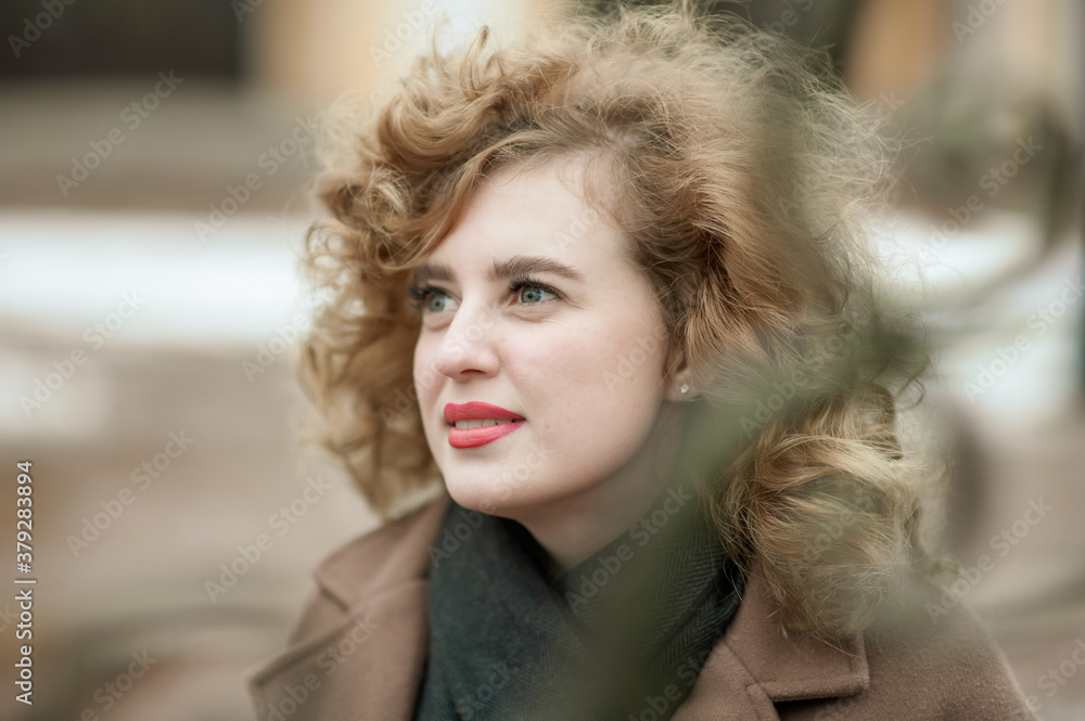 Close-up portrait of curly young woman framed by decorative lattice, red lipstick Close-up portrait of curly young woman framed by decorative lattice, red lipstick