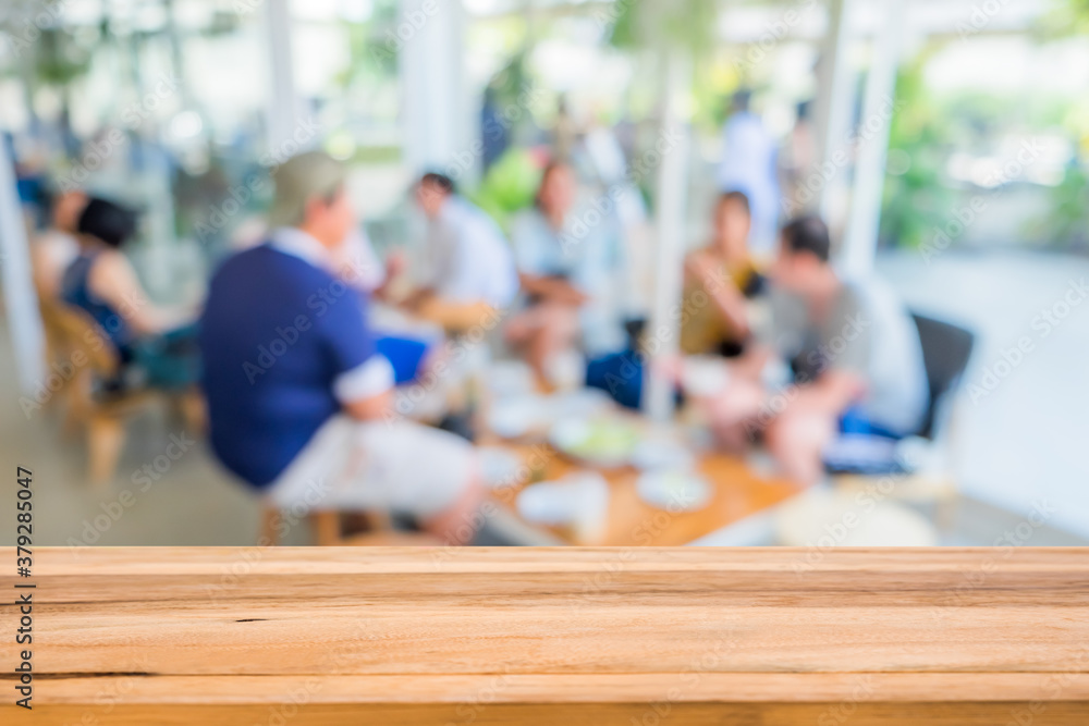 Wood table in front of group young friends come to meet and laughing enjoy in the cafe blur background. Brown wooden desk in front of crowd group talking in coffee shop. Empty counter in restaurant. Wood table in front of group young friends come to meet and laughing enjoy in the cafe blur background. Brown wooden desk in front of crowd group talking in coffee shop. Empty counter in restaurant.