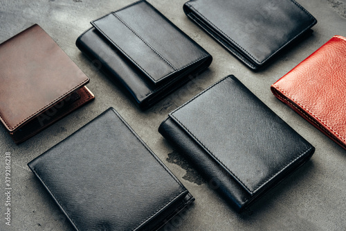 Male leather wallets on grey concrete background