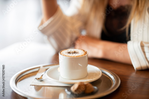 a woman drinking latte coffee in cafe
