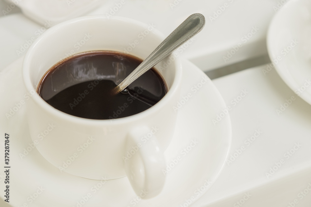 Cup of coffee on wooden table at coffee shop. Hot espresso the best start to any morning at cafe with copy space. Cup of coffee on wooden table at coffee shop. Hot espresso the best start to any morning at cafe with copy space.
