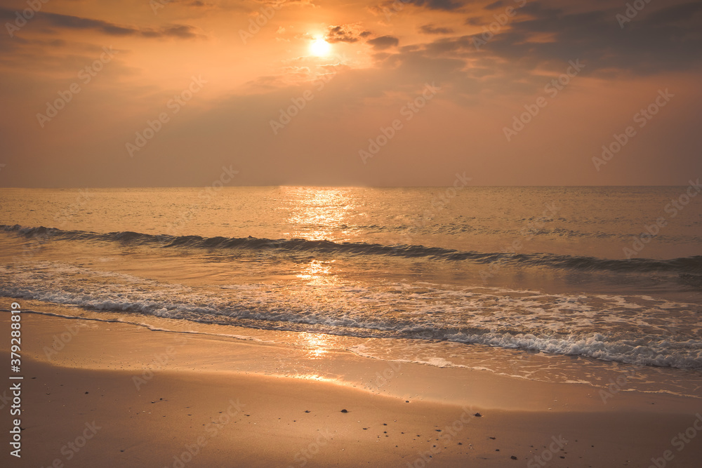 Beautiful golden sunset with blue sky over the horizon on the beach background, Thailand. Tropical twilight colorful sunrise from the landscape sea. Summer ocean vacation concept.