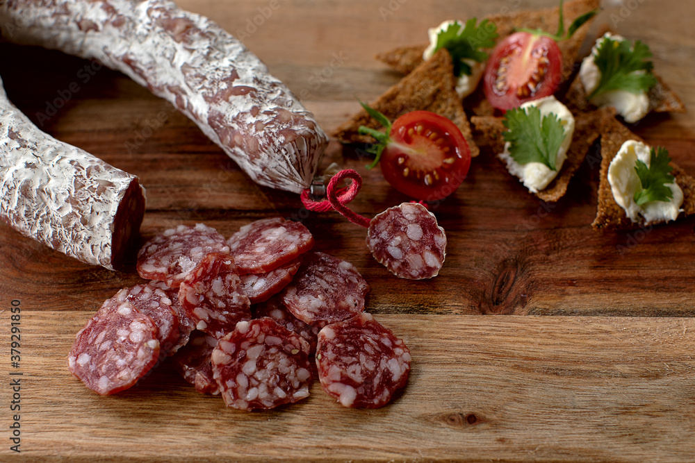 rustic snack, unhealthy but delicious salami combined with healthier foods rustic snack, unhealthy but delicious salami combined with healthier foods