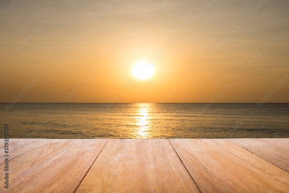 Image of rustic wood table in front of beautiful beach background. Brown wooden empty counter in front of the sea and outdoor sunset.