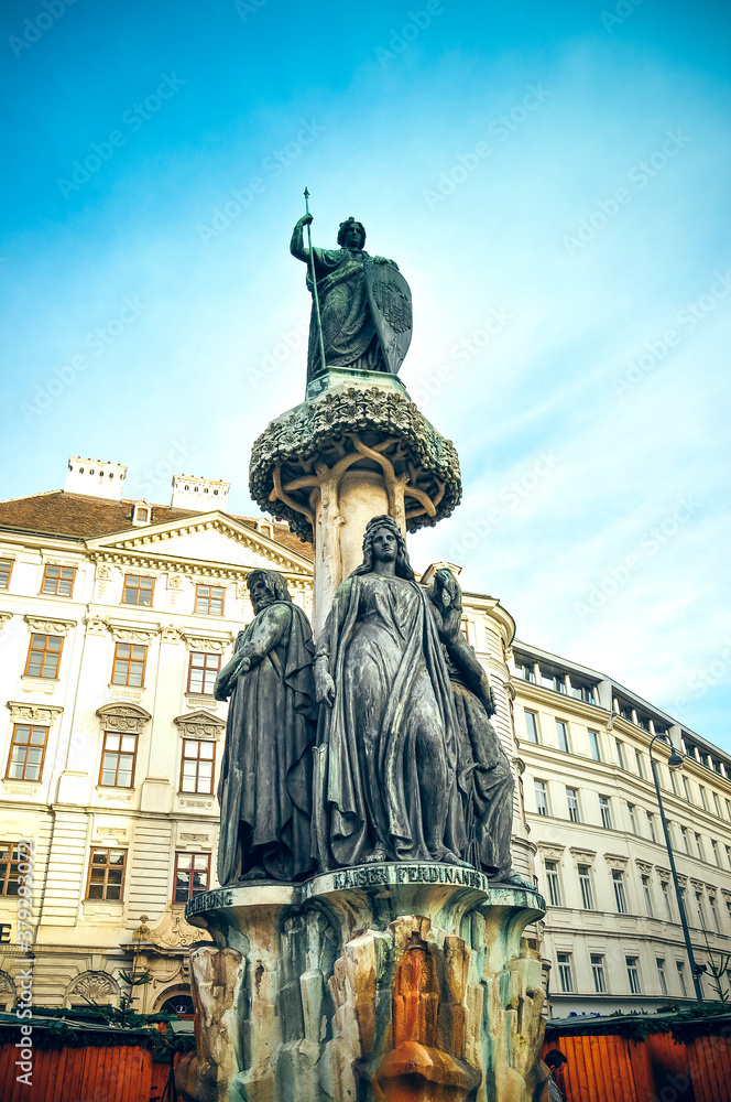 Wien, Austria - sculpture of Austria fountain and flag on Freyung square in Vienna