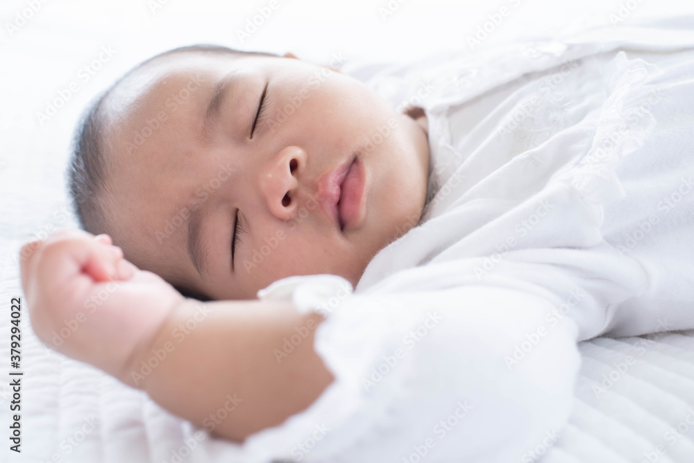 portrait of a beautiful sleeping baby on white. Cute little baby sleeping on bed at home. portrait of a beautiful sleeping baby on white. Cute little baby sleeping on bed at home.