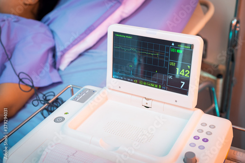 Cropped view of a heart monitor giving vital sign readings during an operation in operating room at the hospital.