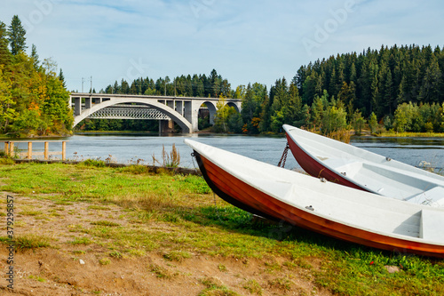 Autumn landscape of bridge and boats on Kymijoki river in Finland, Kouvola, Koria © Elena Noeva