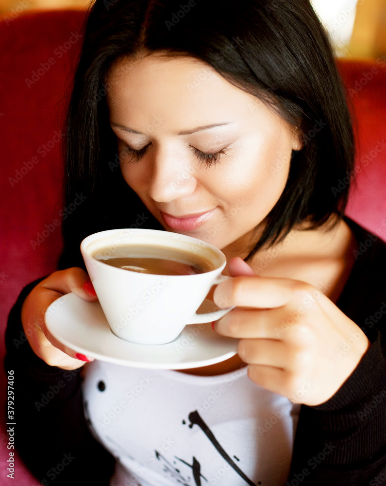 young woman sitting in a cafe drinking coffee young woman sitting in a cafe drinking coffee