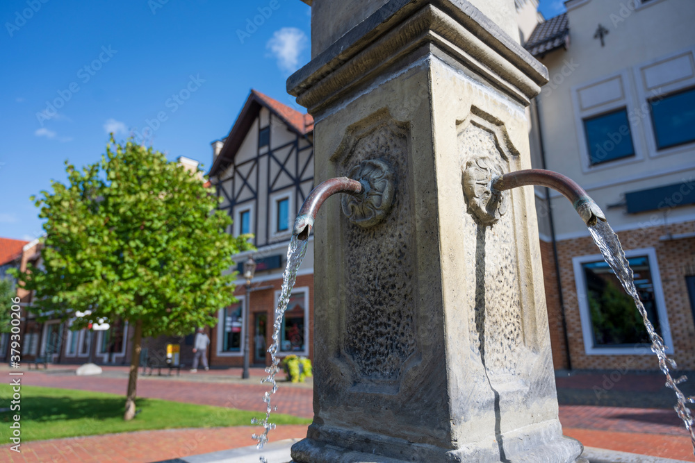 Fountain with drinking water in the center of european town.