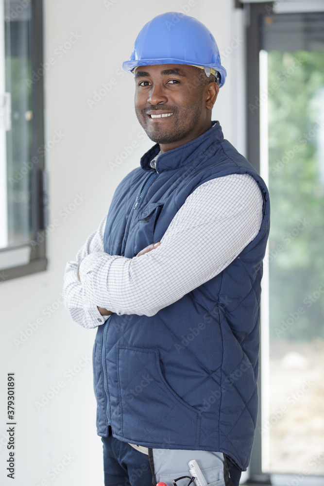 cheerful builder looking at camera cheerful builder looking at camera